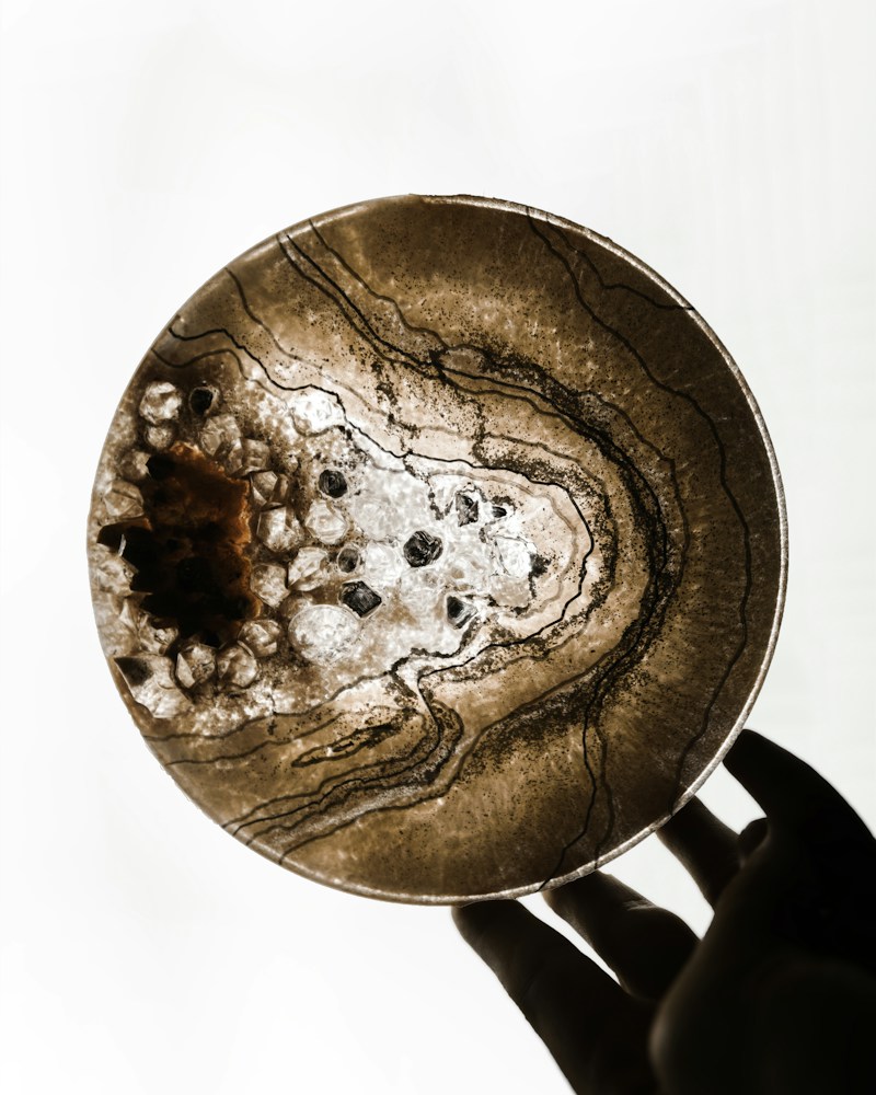 Round resin coaster with sand and brown tonal pour pattern